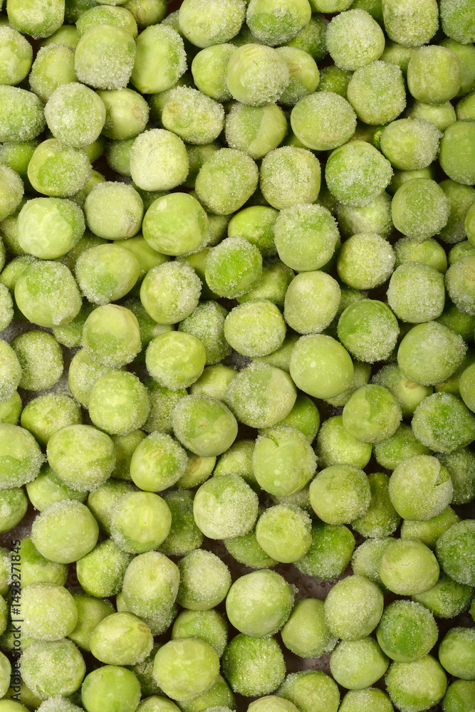 A close-up, top-down shot shows a dense layer of frozen green peas, some with visible ice crystals