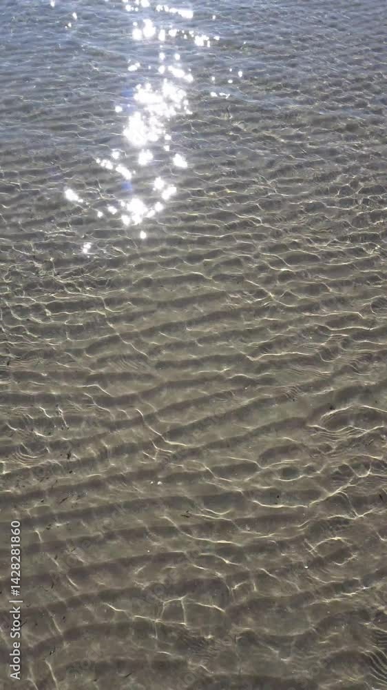 Reflections of the sun on the seashore. Perfect theme for a summer beach vacation. Vertical Video Reflections of the sun on the seashore. Perfect theme for a summer beach vacation. Vertical Video