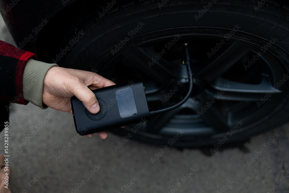 man driver hand inflating tires of vehicle, removing tire valve nitrogen cap for checking air pressure and filling air on car wheel at gas station. self service, maintenance and safety. High quality