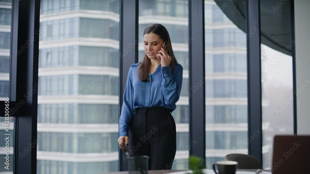 Corporate employee talking mobile phone walking contemporary office space. Corporate employee talking mobile phone walking contemporary office space.