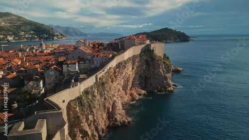 St Lawrence fortress with fortified wall on steep cliff in Dubrovnik Croatia camera moving around. Medieval fort protecting city from conquerors in Adriatic sea aerial panorama