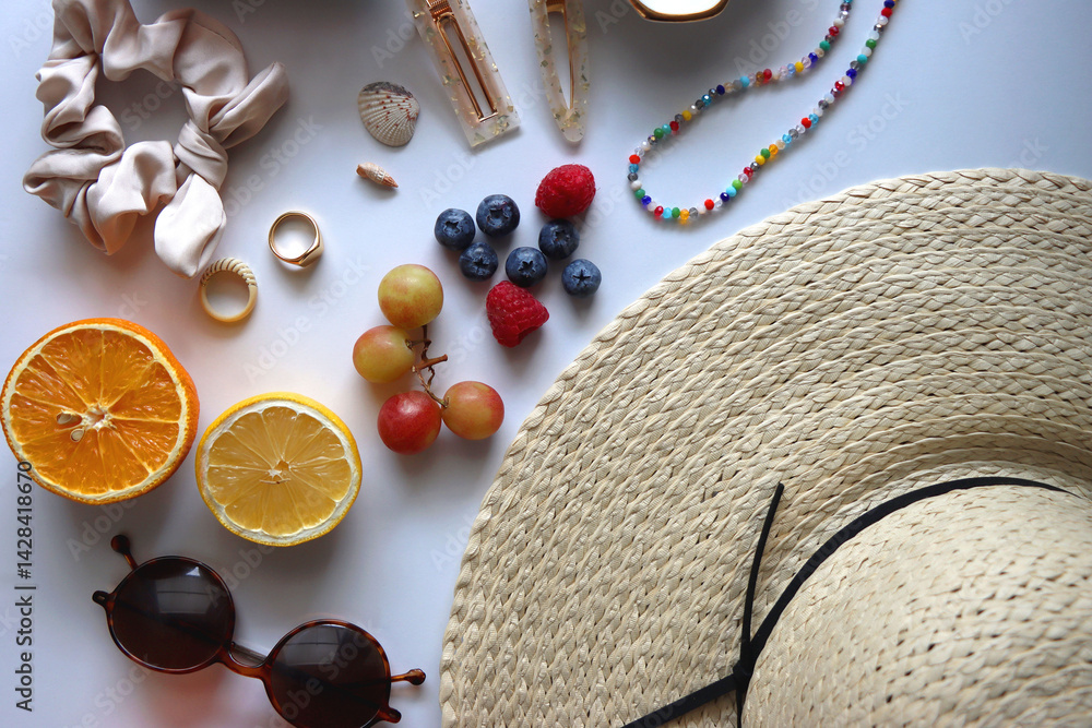 Straw hat, sunglasses, seasonal fruit, seashells and colorful accessories on white backgrounds. Cute summer essentials. Flat lay.