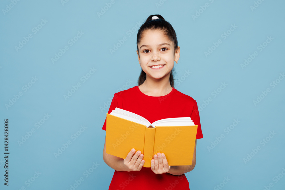Obraz premium Little smart happy kid girl 8-9 years old wears red t-shirt have fun holding read book isolated on pastel light blue color background child studio portrait. Mother's Day love family lifestyle concept.
