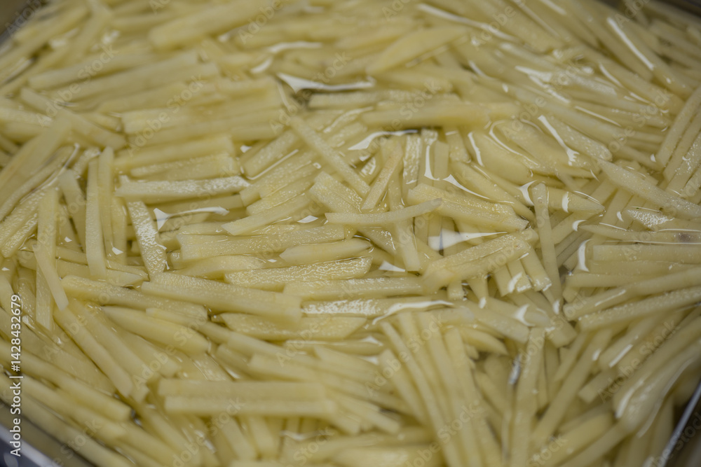 Freshly Shredded Potatoes Soaked in Water for Cooking Preparation Freshly Shredded Potatoes Soaked in Water for Cooking Preparation