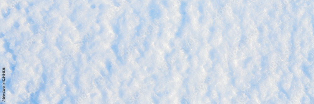 Natural snow texture. The surface of the snow crust. Snowy ground. Winter background with snow patterns. Perfect for Christmas and New Year design. Closeup top view.