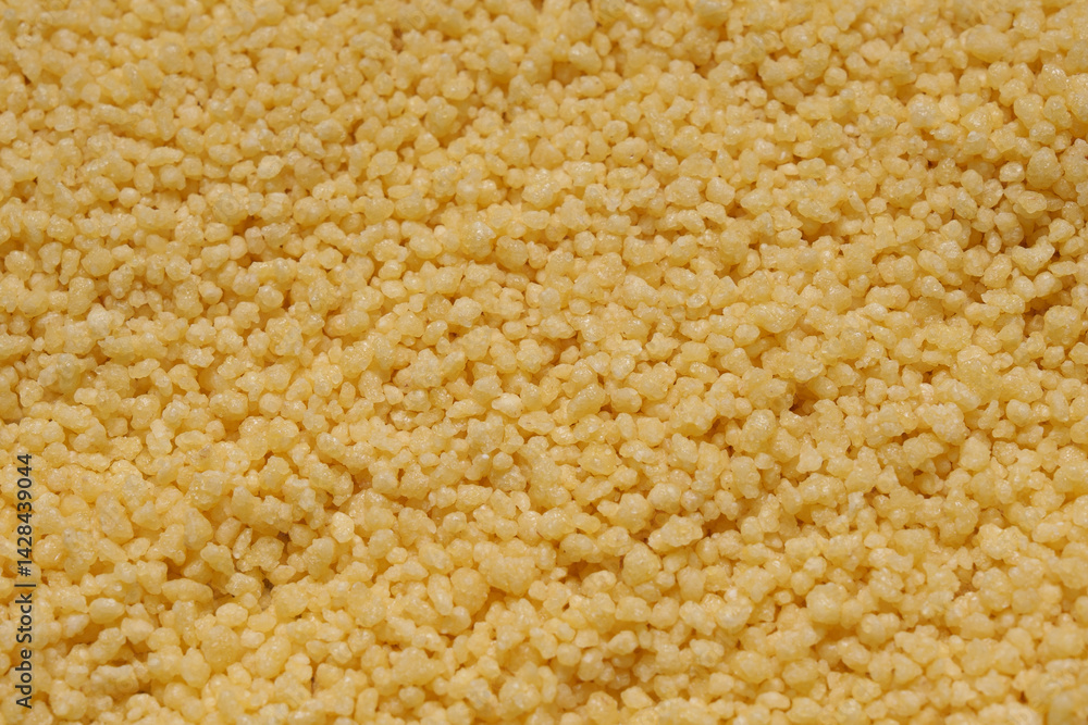 Raw organic couscous as a background, top view. Close-up view. Raw organic couscous as a background, top view. Close-up view.