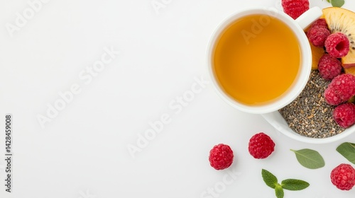 Obraz na płótnie Rejuvenation Through Detox and Nutrient-Rich Wellness Choices, A cup of tea surrounded by fresh raspberries and chia seeds on a clean, white background. w salonie