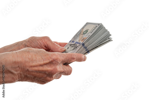 An elderly person holds large stacks of U.S. hundred-dollar bills, symbolizing financial security, wealth, or savings on a clean white background.