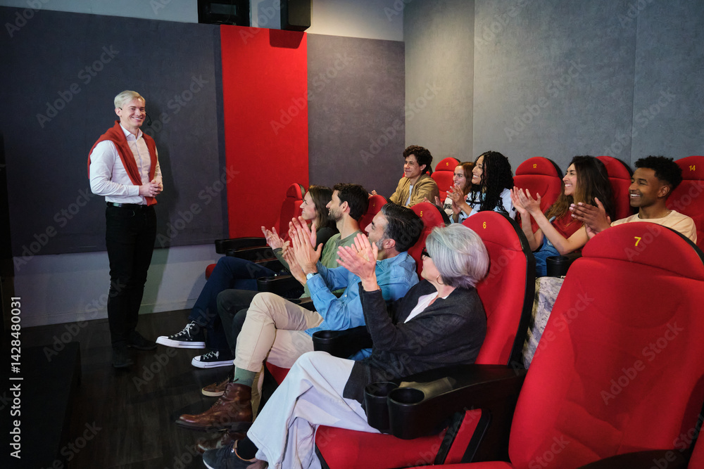 Audience clapping in movie theater after a speaker presentation