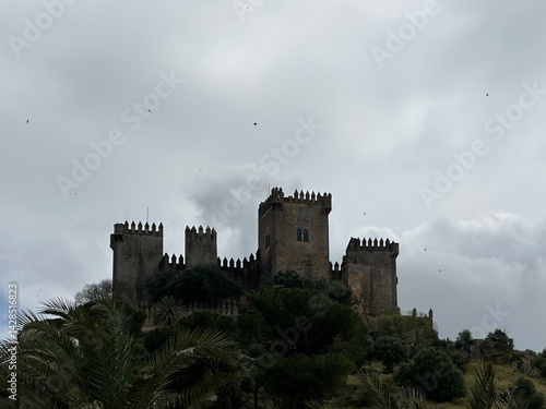 Obraz na płótnie Medieval Castle of Almodóvar del Río oerched atop a hill under a cloudy sky, Andalusia, Spain, April 2024 w salonie