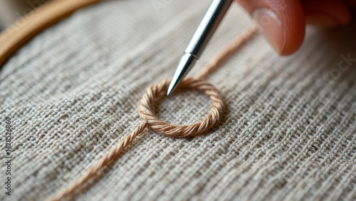 Close-up of hand embroidering twisted thread on fabric with needle