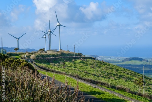 Obraz na płótnie Sustainable Energy Windmills on Picturesque Hilltop Overlooking Coastal Landscape. Serra do Cume Wind Farm with Panoramic View of Praia da Vitoria, Terceira Island, Azores Archipelago w salonie