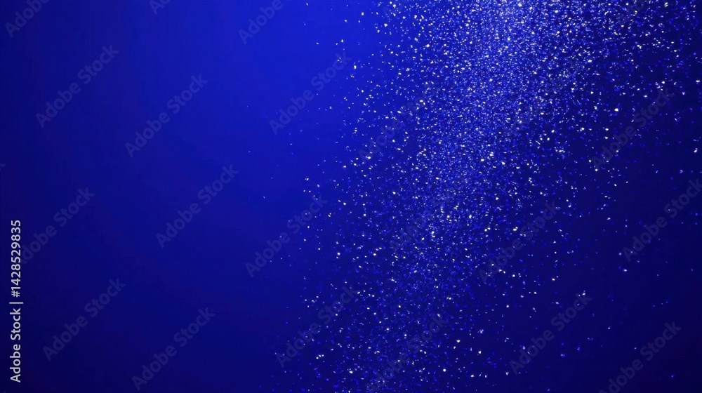 Fototapeta premium Energetic motion of falling confetti over a rich, bold blue background for celebration visuals