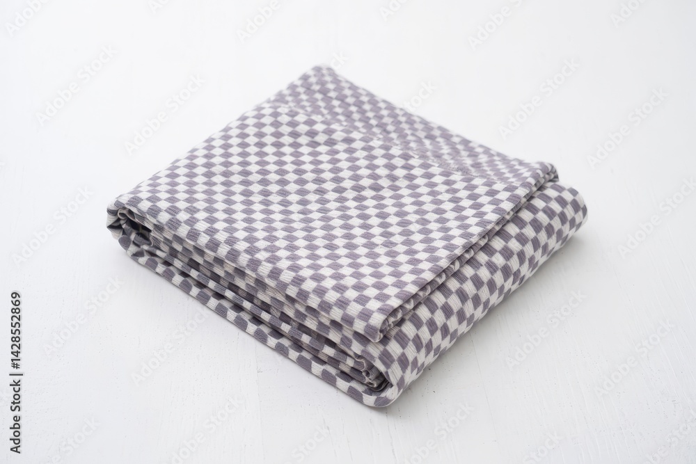 Folded grey and white checkered blanked on an isolated white background Folded grey and white checkered blanked on an isolated white background