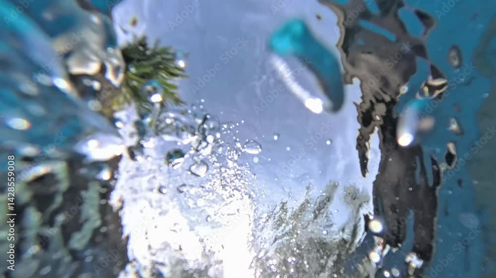 Bubbles rising to surface in swimming pool on sunny day
