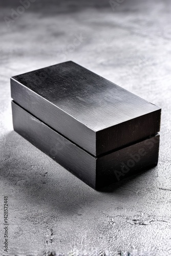 Obraz na płótnie Minimalist Black Wooden Box on Textured Gray Surface for Display w salonie