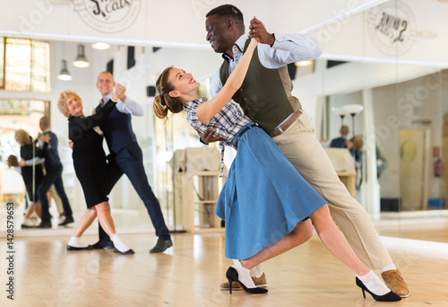 Woman with american man practising ballroom dancing
