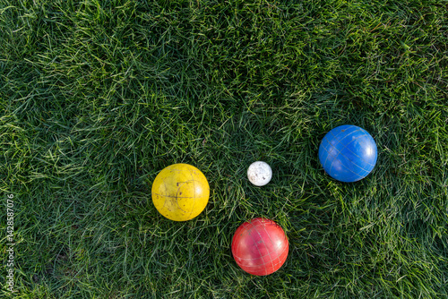 layflat of bocce balls in green grass