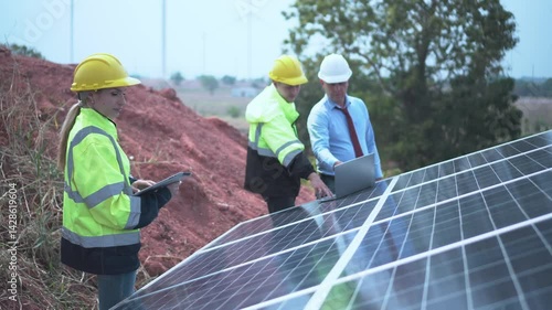 worker with orange helmet at solar panel generator solar power generator plant construction background. solar cell plant and wind generators in farm