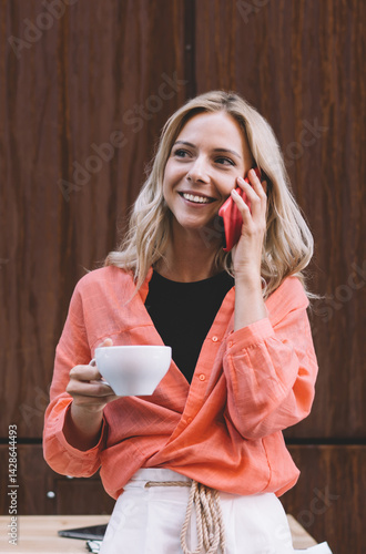 Obraz na płótnie Young woman with cup of coffee and smartphone in creative cafe w salonie