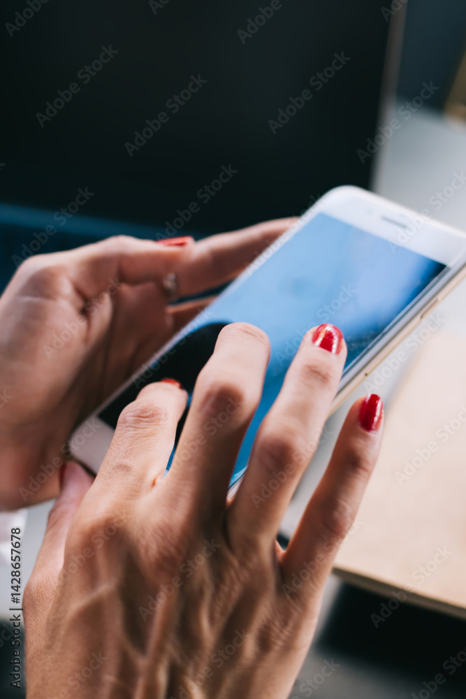 Female's hands typing text messages on empty screen smartphone communicating via online application, cropped image of woman millennial share media and multimedia using mobile phone and 4G internet