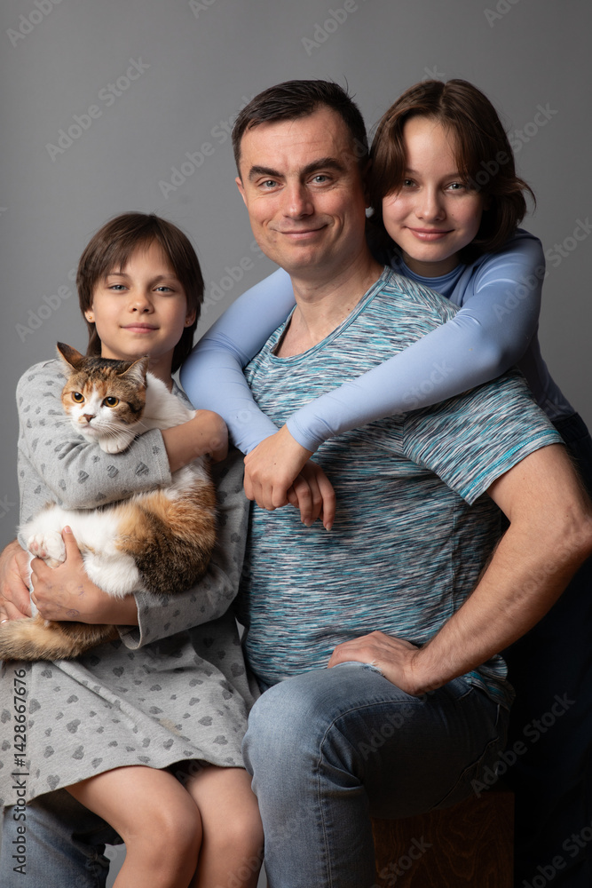 Studio portrait of family: father and daughters