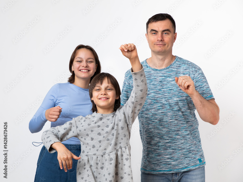 Studio portrait of family: father and daughters