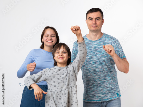 Studio portrait of family: father and daughters