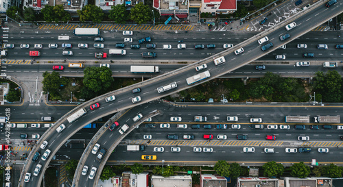 Wallpaper Mural Aerial view of a busy highway with multiple lanes and overpasses filled with cars and trucks moving along Torontodigital.ca