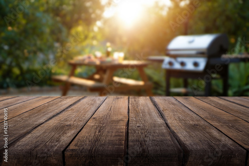 фотографія Empty wooden table and backyard garden background with grill BBQ