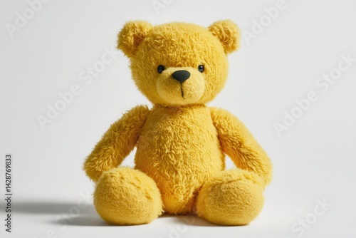 Cute yellow teddy bear plush toy sitting on a clean white background