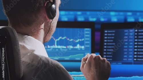 Trader works in office using workstation and analysis technology. Workplace of professional crypto exchange broker. Close-up portrait. Global financial markets, business strategy, currency exchange