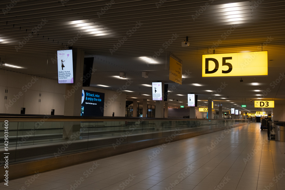 Empty moving walkway in departure area of airport terminal