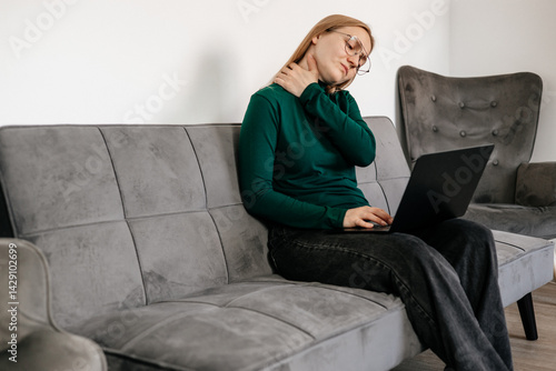 Free Download Young woman taking off glasses and suffering from neck pain at home office
 - GFXLoad