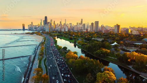Chicago Cityscape at Sunset with Lakefront View. Aerial view of Chicago skyline at sunset, showing Lake Michigan shoreline, tree-lined parks, and a busy roadway along the waterfront.