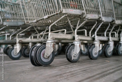Close-up shot of shopping cart wheels with worn-out rubber, stacked together in a storage area.