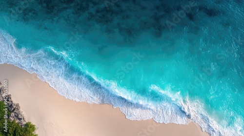 drone-shot aerial view of serene pristine beach capturing turquoise waters meeting soft sand beneath sun showcasing