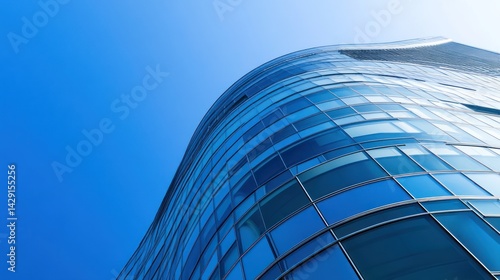 Curved Glass Skyscraper Against a Vivid Blue Sky