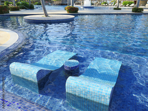 Luxurious Resort Pool with Blue Mosaic Steps and Seating