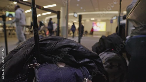 Unattended luggage and jacket at busy airport terminal while waiting for flight