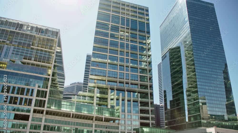 Tall and shiny buildings rise above the bustling city streets, capturing the vibrant energy of urban life Tall and shiny buildings rise above the bustling city streets, capturing the vibrant energy of urban life