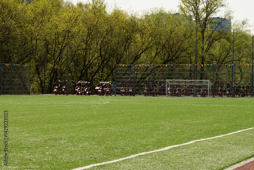 Obraz na płótnie Soccer goal on big field with artificial green grass. Summer season. Outdoor sports activities. w salonie