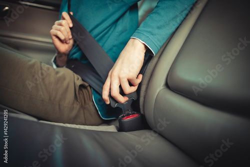 Child buckling seatbelt in car interior for safety