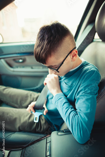 Child buckling seatbelt in car interior for safety