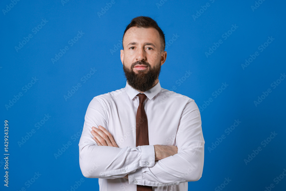 Handsome bearded man in formal outfit on blue background Handsome bearded man in formal outfit on blue background