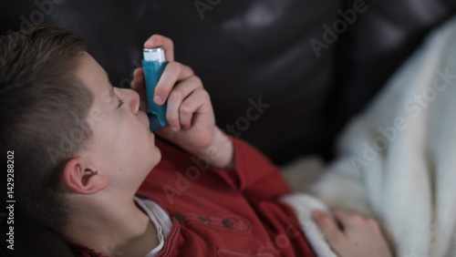 Pediatric asthma – little boy with inhaler at home