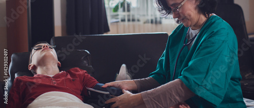 Teen boy receiving home medical care from a doctor