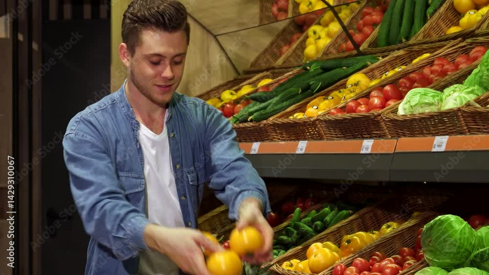 Young man selecting fresh fruits and vegetables at the hypermarket Young man selecting fresh fruits and vegetables at the hypermarket
