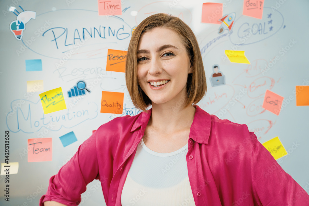 Portrait of young beautiful caucasian businesswoman smiling and posing with confident while looking at camera in front of whiteboard with mind map and colorful sticky notes. Closeup. Immaculate. Portrait of young beautiful caucasian businesswoman smiling and posing with confident while looking at camera in front of whiteboard with mind map and colorful sticky notes. Closeup. Immaculate.