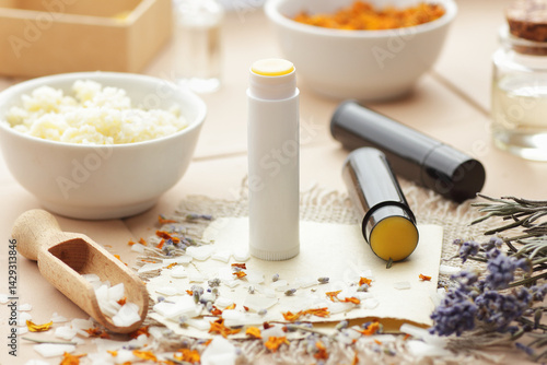 Diy lip balms, emulsifier in a wooden spoon with cosmetic ingredients and shea butter in a bowl